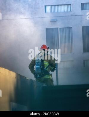 Los Angeles, CA, USA – November 3, 2022: Los Angeles Fire Department firefighters put out a house fire on Martel street in Los Angeles, CA. Stock Photo
