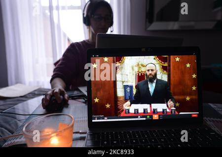 A woman watches Rabbi Menachem Margolin, the Chairman and the founder of European Jewish Association (EJA), speaking during online commemoration of the International Holocaust Remembrance Day. Due to the coronavirus pandemic, the EJA commemoration event is held online. On Wednesday, January 27, 2021 in Dublin, Ireland. (Photo by Artur Widak/NurPhoto) Stock Photo