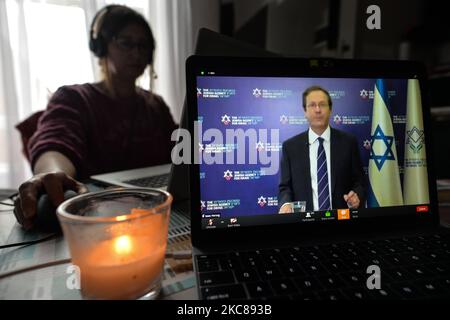 A woman watches Isaak Herzog, Chairman of the Jewish Agency for Israel, speaking during online commemoration of the International Holocaust Remembrance Day. Due to the coronavirus pandemic, the EJA commemoration event is held online. On Wednesday, January 27, 2021 in Dublin, Ireland. (Photo by Artur Widak/NurPhoto) Stock Photo