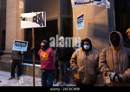 Line 3 protesters stand outside the Army Corp of Engineers building in downtown St. Paul, MN. January 29, 2021. Nearly 600 activists and water protectors took part in a protest against the Enbridge Line 3 pipeline on Friday evening in St. Paul, Minnesota. The event was organized by over a dozen groups, including Sunrise Movement MN, Honor the Earth, International Indigenous Youth Council, Environment MN, MN350, and others. Participants called for Governor Tim Walz as well as the Army Corp of Engineers to revoke the pipeline's permit on environmental safety and humanitarian grounds, as well as  Stock Photo