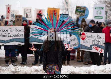 A member of the Kalpulli Yaocenoxtli Aztec cultural group performs a dance during the Line 3 pipeline protest in downtown St. Paul, MN. January 29, 2021. Nearly 600 activists and water protectors took part in a protest against the Enbridge Line 3 pipeline on Friday evening in St. Paul, Minnesota. The event was organized by over a dozen groups, including Sunrise Movement MN, Honor the Earth, International Indigenous Youth Council, Environment MN, MN350, and others. Participants called for Governor Tim Walz as well as the Army Corp of Engineers to revoke the pipeline's permit on environmental sa Stock Photo