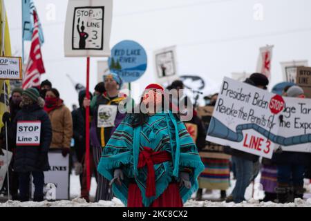 A member of the Kalpulli Yaocenoxtli Aztec cultural group performs a dance during the Line 3 pipeline protest in downtown St. Paul, MN. January 29, 2021. Nearly 600 activists and water protectors took part in a protest against the Enbridge Line 3 pipeline on Friday evening in St. Paul, Minnesota. The event was organized by over a dozen groups, including Sunrise Movement MN, Honor the Earth, International Indigenous Youth Council, Environment MN, MN350, and others. Participants called for Governor Tim Walz as well as the Army Corp of Engineers to revoke the pipeline's permit on environmental sa Stock Photo