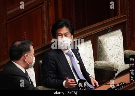 Japan's Health, Labor and Welfare Minister Norihisa Tamura (C) talks with a congressman in the lower house before a debate session regarding the bills to introduce fines for people and businesses failing to comply with the country's measures to stop the pandemic in Japan's lower house in Tokyo, Japan on February 1, 2021. (Photo by Jinhee Lee/NurPhoto) Stock Photo