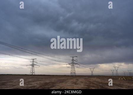 The masts of the power line against the cloudy sky Stock Photo - Alamy