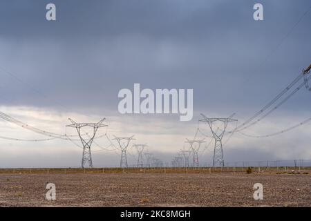Power line masts and cloudy sky Stock Photo - Alamy