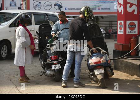 People refilling petrol and diesel fuel in their vehicles at a fuel station on February 13, 2021 in Guwahati, India. Ahead of assembly elections, the Assam government has decided to reduce prices of petrol and diesel in Assam by Rupees 5 per litre from Friday midnight, making the fuels among the least costly in the country. Assam government has removed the additional tax of Rs 5 levied on petrol and diesel levied last year at the peak of Covid-19 pandemic. (Photo by David Talukdar/NurPhoto) Stock Photo