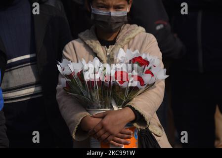 A Girl selling Red rose flower on the occasion of Valentine’s Day in Patan Durbar Square, Lalitpur, Nepal on Sunday, February 14, 2021. (Photo by Narayan Maharjan/NurPhoto) Stock Photo