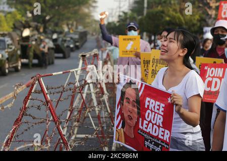 A Myanmar protester cries in front of armoured vehicles during a demonstration against the military coup outside the Central Bank in Yangon, Myanmar on February 15, 2021. (Photo by Myat Thu Kyaw/NurPhoto) Stock Photo