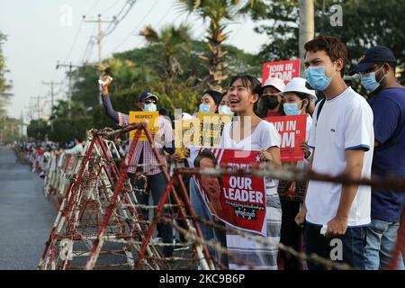 A Myanmar protester cries in front of armoured vehicles during a demonstration against the military coup outside the Central Bank in Yangon, Myanmar on February 15, 2021. (Photo by Myat Thu Kyaw/NurPhoto) Stock Photo