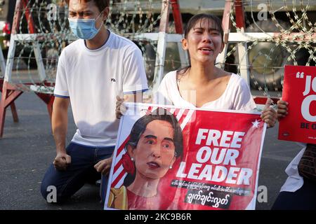 A Myanmar protester cries in front of armoured vehicles during a demonstration against the military coup outside the Central Bank in Yangon, Myanmar on February 15, 2021. (Photo by Myat Thu Kyaw/NurPhoto) Stock Photo