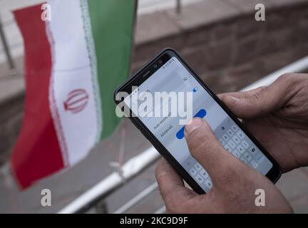 An Iranian park guard enters password on his smartphone as he tries to connect to an Irancell 5G network through the Huawei modem in northern Tehran on February 16, 2021. Iran’s first 5G network has ran by the Irancell company which is an Iranian telecommunications company that operates Iran's largest 2G-3G-4G-4.5G also 5G mobile network, and fixed wireless TD-LTE internet services. (Photo by Morteza Nikoubazl/NurPhoto) Stock Photo
