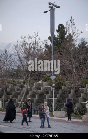Iranian families walk past 5G telecommunications equipment on a MTN-Irancell tower in the Water and Fire park in northern Tehran on February 16, 2021. Iran’s first 5G network has ran by the Irancell company which is an Iranian telecommunications company that operates Iran's largest 2G-3G-4G-4.5G also 5G mobile network, and fixed wireless TD-LTE internet services. (Photo by Morteza Nikoubazl/NurPhoto) Stock Photo