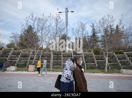 Iranian people walk past 5G telecommunications equipment on a MTN-Irancell tower in the Water and Fire park in northern Tehran on February 16, 2021. Iran’s first 5G network has ran by the Irancell company which is an Iranian telecommunications company that operates Iran's largest 2G-3G-4G-4.5G also 5G mobile network, and fixed wireless TD-LTE internet services. (Photo by Morteza Nikoubazl/NurPhoto) Stock Photo