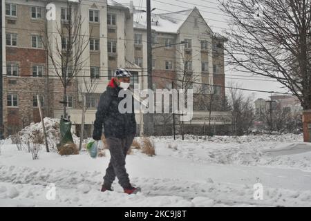 Man walks along the sidewalk as a snowstorm dropped 10-15 centimeters of snow across the city of Toronto, Ontario, Canada, on February 18, 2021. (Photo by Creative Touch Imaging Ltd./NurPhoto) Stock Photo