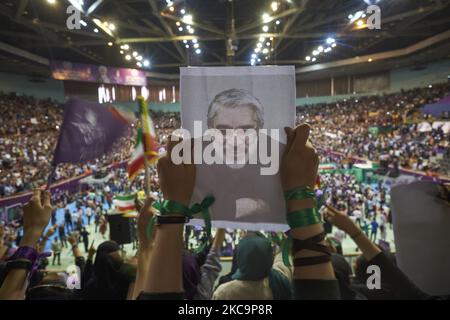 A supporter of the reformist President and 2017 Presidential Election candidate, Hassan Rouhani, holds-up a portrait of the Iranian leader of the opposition in the 2009 post-election unrests, Mir-Hossein Mousavi as she attends the 12000-sit Azadi (Freedom) sport complex during a campaign rally in western Tehran, May 13, 2017. Rouhani re-elected as President of Iran. (Photo by Morteza Nikoubazl/NurPhoto) Stock Photo