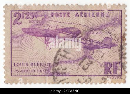 FRANCE - 1934 September 1: An 2,25 francs violet Air Post stamp depicting Bleriot’s Monoplane. 1st flight across the English Channel, by Louis Charles Joseph Bleriot. French aviator, inventor, and engineer. Blériot was the first to use the combination of hand-operated joystick and foot-operated rudder control as used to the present day to operate the aircraft control surfaces. Blériot was also the first to make a working, powered, piloted monoplane. In 1909 he became world-famous for making the first airplane flight across the English Channel, winning the prize of £1,000 Stock Photo