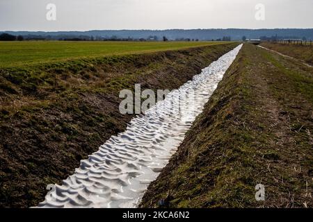 A view of rests of snow from the Darcy storm can be seen in a little canal between fields, during the first weekend of warmer temperatures, in The Netherlands, on February 20th, 2021. (Photo by Romy Arroyo Fernandez/NurPhoto) Stock Photo