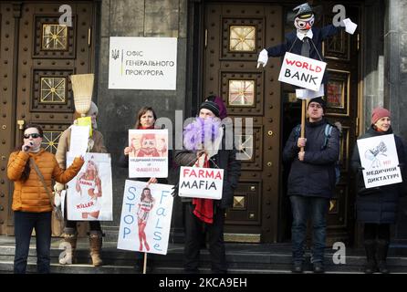 Anti-vaccination demonstrators hold placards that read 'Medical coercion is fascism', 'No medical dictatorship! ',' Hands off our children 'and others, during a protest against vaccination with India-made ?oviShield (Oxford/AstraZeneca) COVID-19 coronavirus vaccine, near the Office of the Prosecutor General in Kyiv, Ukraine on 3 March 2021. On 24 February Ukraine has begun vaccinating against coronavirus COVID-19 disease after receiving the day before first batch of 500 thousand doses of Indian-made ?oviShield (Oxford/AstraZeneca) vaccine, but faces a battle against vaccine skepticism, as medi Stock Photo