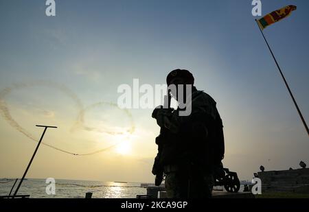 A Sri Lankan Air Force soldier stands guard as the Indian air force helicopters display team creates a Heart-shape in the sky during an event to mark Sri Lanka air force 70th-anniversary, Air Show, at Colombo, Sri Lanka. Wednesday 3 March 2021 (Photo by Tharaka Basnayaka/NurPhoto) Stock Photo