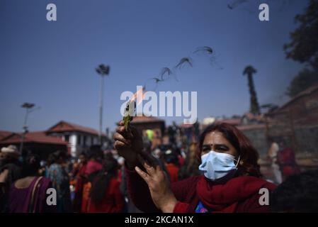 A devotee offering butter lamps during Maha Shivaratri at Kathmandu, Nepal on Thursday, March 11, 2021. Less number of Hindu Sadhu or Holy man from India and Nepal arrive at Pashupatinath Premises to celebrate Festival due to Covid-19. (Photo by Narayan Maharjan/NurPhoto) Stock Photo