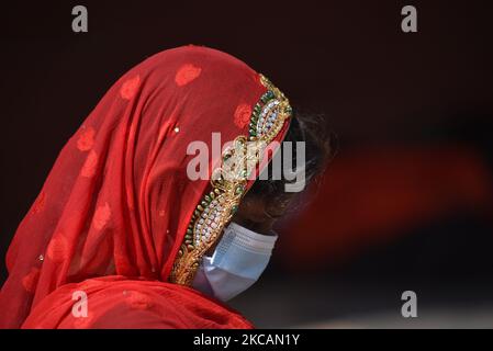 A Nepalese devotee lining to offer ritual prayer along with facemask around the premises of Pashupatinath Temple, Kathmandu, Nepal on Thursday, March 11, 2021. Less number of Hindu Sadhu or Holy man from India and Nepal arrive at Pashupatinath Premises to celebrate Festival due to Covid-19. (Photo by Narayan Maharjan/NurPhoto) Stock Photo