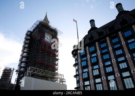 The under-renovation Elizabeth Tower of the Houses of Parliament (commonly known as Big Ben) stands surrounded by scaffolding opposite Portcullis House in London, England, on March 11, 2021. This week marked the first stage of coronavirus lockdown easing across England, with schools reopening and some limits on social contact loosened. Non-essential shops, bars, restaurants and other hospitality and leisure businesses remain closed, however, and will not reopen until next month under the current timetable. (Photo by David Cliff/NurPhoto) Stock Photo