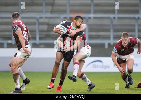 Kallum Watkins of Salford Red Devils is tackled during the pre-season match between Salford Red Devils and Wigan Warriors at AJ Bell Stadium, Eccles, UK on 14th March 2021. (Photo by Pat Scaasi/MI News/NurPhoto) Stock Photo