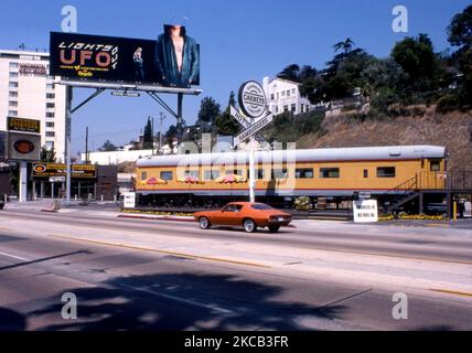 Billboard for the band UFO over Carney's diner car on the Sunset Strip in Los Angeles, CA, 1977 Stock Photo