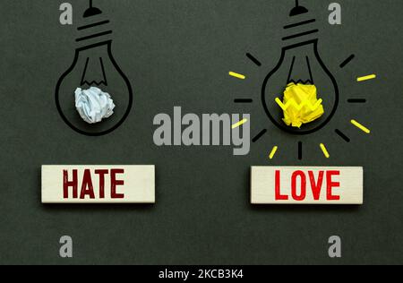 Word love macro, words LOVE and HATE on wooden blocks and light bulbs Stock Photo