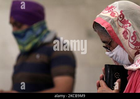A devotee wearing a mask prays at the Gurudwara Sis Ganj Sahib, amidst the spread of the coronavirus disease (COVID-19), in New Delhi on March 20, 2021. India saw 43,846 new coronavirus infections in a day, the highest single-day rise recorded so far this year, taking the nationwide Covid-19 tally to 1,15,99,130, according to the Union Health Ministry data updated on Sunday. (Photo by Mayank Makhija/NurPhoto) Stock Photo