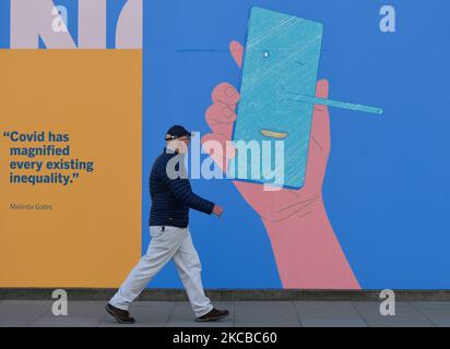 A man walks past a COVID-19 related display at the Science Gallery in Dublin, during Level 5 Covid-19 lockdown. One year after COVID closed Gallery doors for the first time - Science Gallery Dublin launched a new programme called IN THESE STRANGE TIMES: an evolving series created in response to the global pandemic. On Tuesday, March 23, 2021, in Dublin, Ireland. (Photo by Artur Widak/NurPhoto) Stock Photo