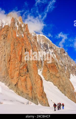 Mountaineers cross the Glacier du Geant. Behind them is the Mont Blanc du Tacul. Stock Photo