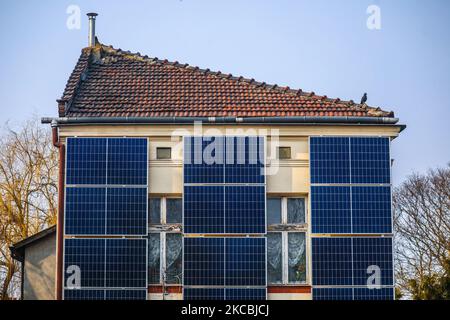 A number of solar collector panels are attached to the front wall of an old house in the center of Krakow, Poland on March 26, 2021. The recent boom in solar energy has been fuelled in part by photovoltaic micro-installations on people’s homes, supported by a successful state subsidy scheme. The development comes as the government seeks to gradually transition away from reliance on coal, with renewables playing an ever larger role in the country’s energy mix. (Photo by Beata Zawrzel/NurPhoto) Stock Photo