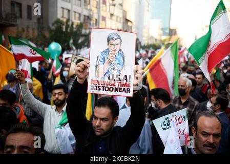 A man holds up an anti-U.S. placard during an annual demonstration in front of the former U.S. Embassy in Tehran, Iran, Friday, Nov. 4, 2022. Iran on Friday marked the 1979 takeover of the U.S. Embassy in Tehran as its theocracy faces nationwide protests after the death of a 22-year-old woman earlier arrested by the country's morality police. The shirt of the young man on the poster contains a picture of the late Revolutionary Guard Gen. Qassem Soleimani, who was killed in Iraq in a U.S. drone attack in 2020. (Photo by Sobhan Farajvan/Pacific Press) Stock Photo