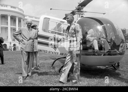 Dwight Eisenhower alighting from a helicopter on the White House South Lawn. Stock Photo