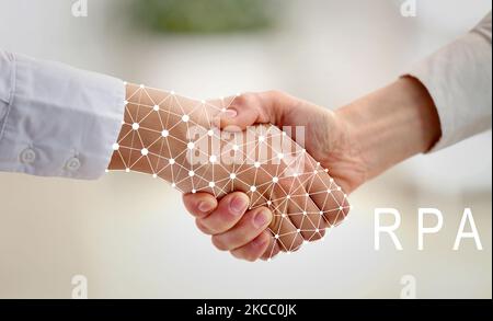 Businesswomen shaking hands in office. Concept of robotic process automation Stock Photo