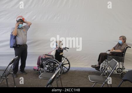 Older adults in the observation area inside the facilities of the Mexico City Electric Transportation Service, after being immunized with the Sputnik V biologic against COVID-19 , during the sanitary emergency and the orange epidemiological traffic light in the capital. (Photo by Gerardo Vieyra/NurPhoto) Stock Photo