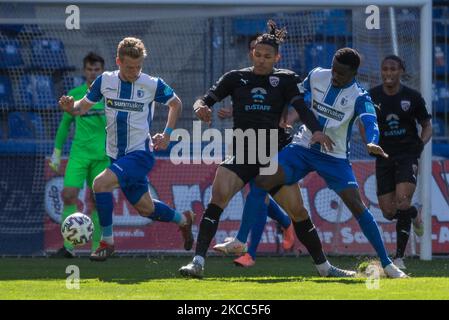 Dominik Ernst (left) of Magdeburg, Justin Butler of Ingolstadt (second from left) and Sirlord Conteh (right) of Magdeburg battle for the ball during the 3. Liga match between 1. FC Magdeburg and FC Ingolstadt 04 at MDCC-Arena on April 03, 2021 in Magdeburg, Germany. (Photo by Peter Niedung/NurPhoto) Stock Photo