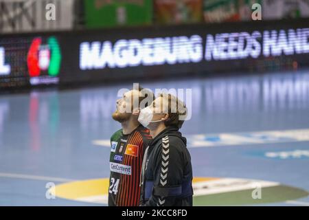 the injured Gisli Kristjánsson (right) and Christian O'Sullivan (left) of Magdeburg looks on after the LIQUI MOLY Handball-Bundesliga match between SC Magdeburg and SG Flensburg-Handewitt at GETEC-Arena on April 04, 2021 in Magdeburg, Germany. (Photo by Peter Niedung/NurPhoto) Stock Photo