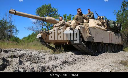 Soldiers take a short break atop their battle tank. Stock Photo