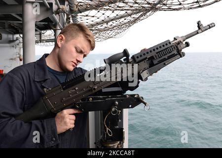 Gunnerâ€™s Mate Seaman mounts a 240B machine gun. Stock Photo