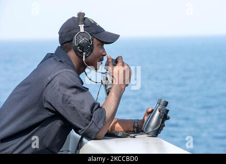 Boatswain's Mate Seaman uses a sound powered telephone. Stock Photo