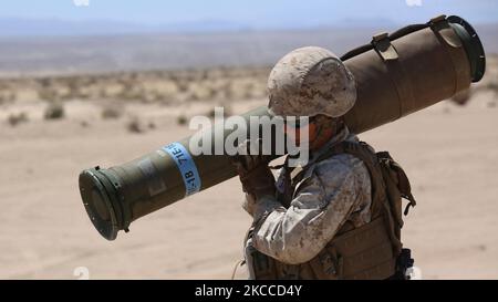 U.S. Marine carries a tube-launched, optically-tracked, wire-guided missile. Stock Photo