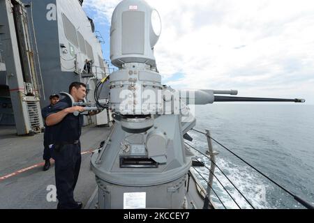 Gunner's Mate performs maintenance on an MK-38 MOD 2 25-mm machine gun. Stock Photo