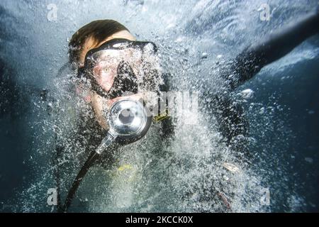 U.S. Navy Petty Officer enters the water off the coast of Guantanamo Bay, Cuba. Stock Photo