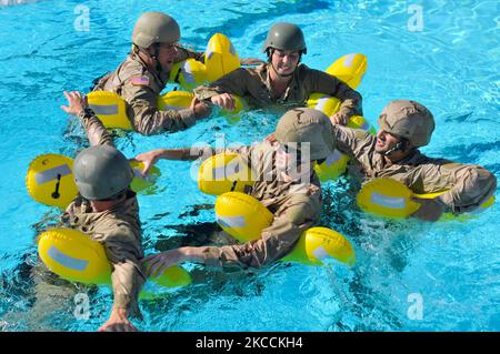 U.S. Coast Guardsmen form a human raft during water survival training. Stock Photo