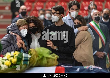 In the picture from the left the mother of Michele Pasinato hugs