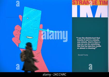 A woman walks past a COVID-19 related display at the Science Gallery in Dublin, during Level 5 Covid-19 lockdown. One year after COVID closed Gallery doors for the first time - Science Gallery Dublin launched a new programme called IN THESE STRANGE TIMES: an evolving series created in response to the global pandemic. On Tuesday, 13 April 2021, in Dublin, Ireland. (Photo by Artur Widak/NurPhoto) Stock Photo