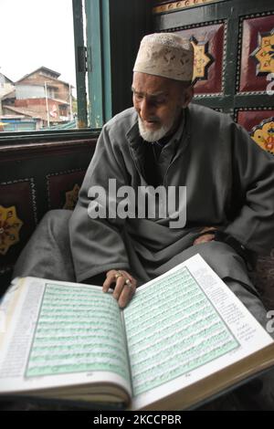 A Kashmiri man reads Holy Quran on the first day of Ramadan inside a ...