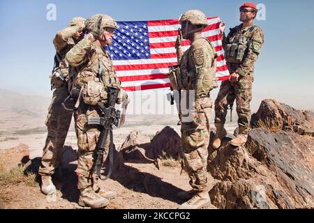 A U.S. Army Soldier is reenlisted atop Pride Rock mountain in Afghanistan. Stock Photo